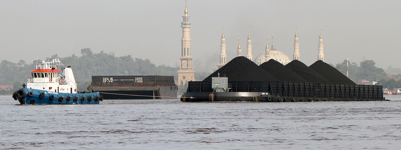 Coal barge in front of temples in Indonesia